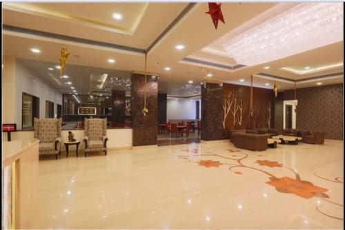 a lobby with chairs and a living room at Ramada Jamshedpur Bistupur in Jamshedpur