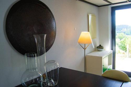 two wine glasses sitting on a counter with a lamp at Private Villa with pool and magnificent view in Ceissa
