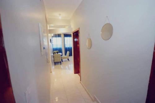 a hallway leading to a room with a living room at Stone House - Makepe, Douala in Douala