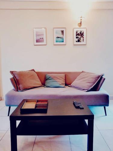 a couch in a living room with a coffee table at Stone House - Makepe, Douala in Douala