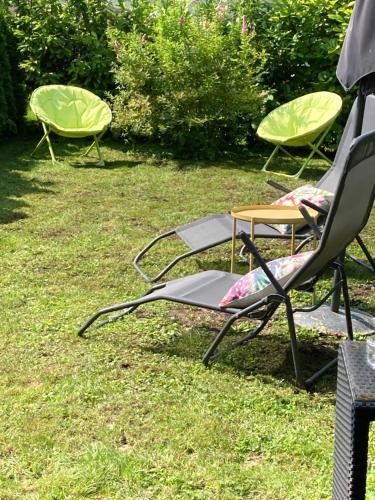 a group of lawn chairs sitting in the grass at Kal's Studio Apartment Salzburg in Salzburg