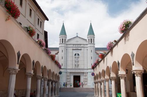 a white building with steep towers on a street at L'oasi di zio Franco - Cascata delle Marmore - Valnerina - Umbria in Rosciano