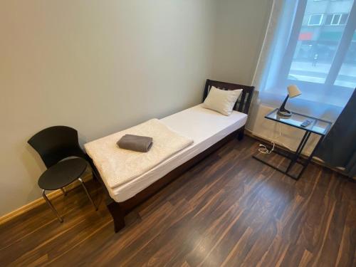 a small room with a bed and a table and a chair at ApartHotel Riga in Rīga