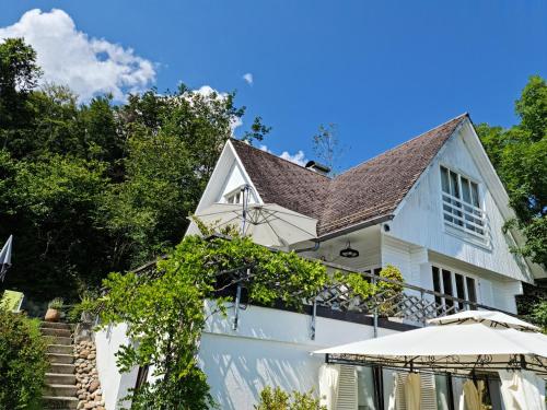 a white house with a roof at Mont Blanc Chalet in Grandevent