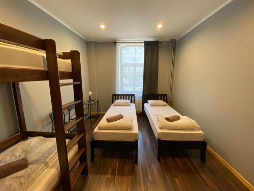 a room with two bunk beds and a window at ApartHotel Riga in Rīga