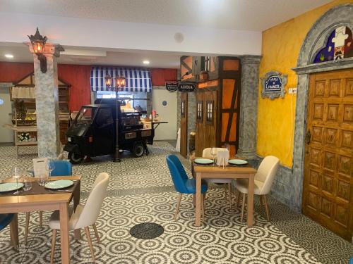 a dining room with two tables and chairs in a room at O frances in Nelas
