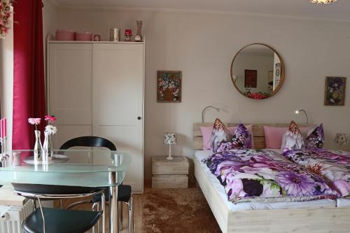 a bedroom with a bed and a table and a mirror at Apartment Anastasia in Garmisch-Partenkirchen