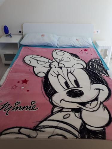 a bed with a drawing of a mickey mouse on it at The Olive Garden in Šibenik