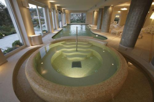 a jacuzzi tub in a large building with columns at Villa Maria Hotel & SPA in Francavilla al Mare