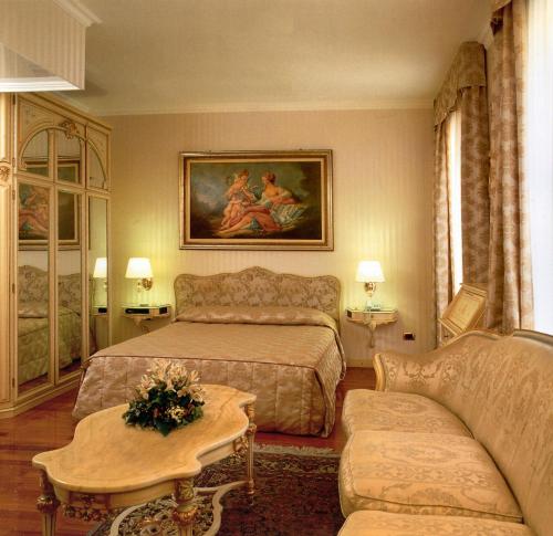 A bed or beds in a room at Andreola Central Hotel