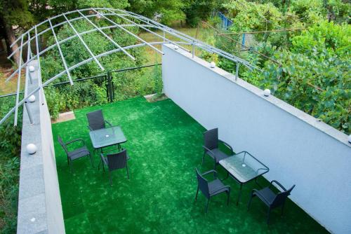 an overhead view of a patio with tables and chairs at Likani Home in Borjomi