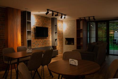 a living room with two tables and a couch at Likani Home in Borjomi