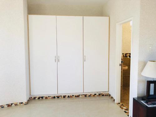 a large white cabinet in a room with a lamp at Eco Hotel Katarma in Puerto Baquerizo Moreno