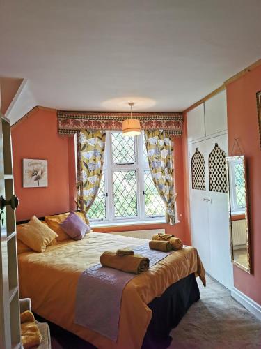 a bedroom with a bed with two towels on it at PEACEFUL RETREAT HIDEAWAY SURREY in Esher