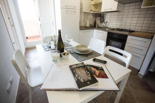 a kitchen with a table with a book on it at SEA- ROOM-E in Ladispoli