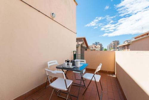 a small patio with a table and chairs on a balcony at SEA- ROOM-E in Ladispoli