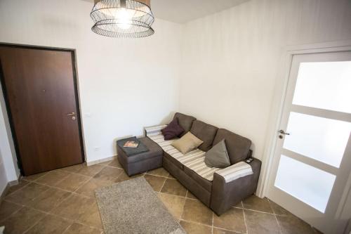a living room with a couch and a door at SEA- ROOM-E in Ladispoli