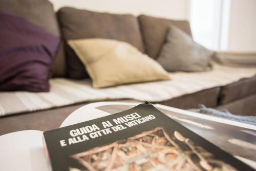 a book sitting on a table in front of a couch at SEA- ROOM-E in Ladispoli