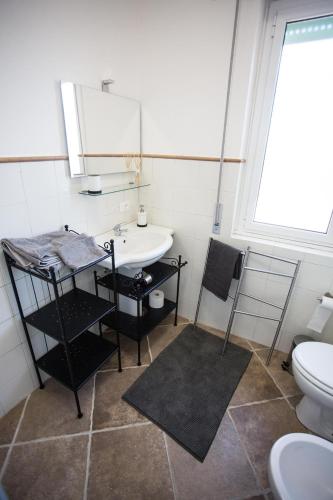 a bathroom with a sink and a toilet at SEA- ROOM-E in Ladispoli
