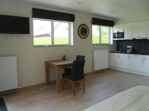 a room with a table and a kitchen with a counter at B&B Caramel in Turnhout