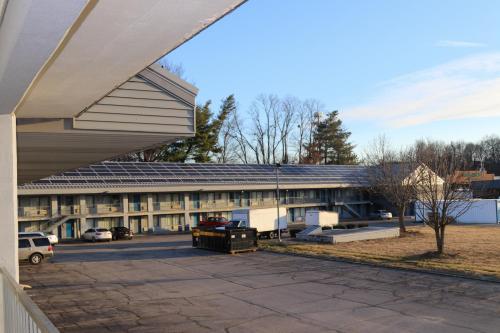 an external view of a building with a parking lot at Envi Boutique Hotel Henderson-Evansville South in Henderson