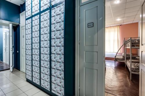 a room with blue walls and a wall covered in boxes at Mister Hostel in Lviv