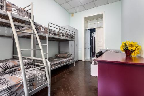 a room with two bunk beds and a counter at Mister Hostel in Lviv