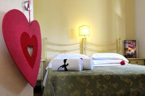 a bedroom with a bed with a red heart on the wall at Poggio di Luna Adults Only in Peschici