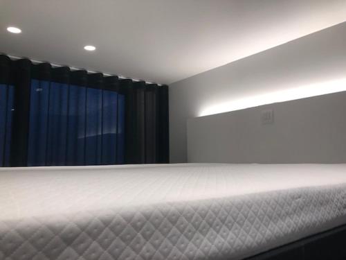 a bedroom with a white bed and a window at bloc79/zero in Knokke-Heist