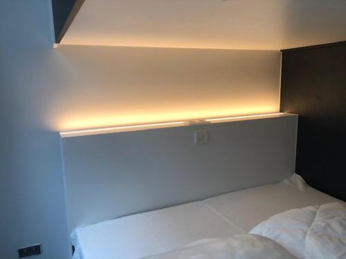 a bedroom with a bed with a light above it at bloc79/zero in Knokke-Heist