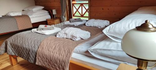 a bedroom with two beds with towels on them at Cichy Zakątek in Ujsoły