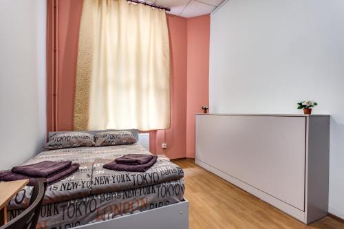 a bedroom with two beds and a window at Mister Hostel in Lviv