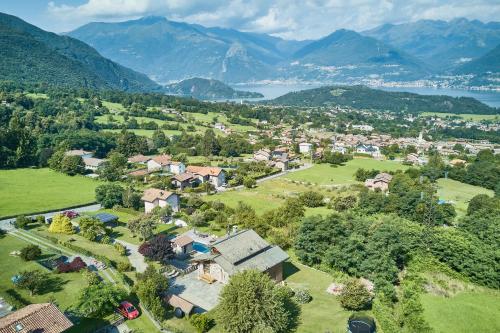 an aerial view of a small town with a lake and mountains at chalet con piscina e vista panoramica in Colico