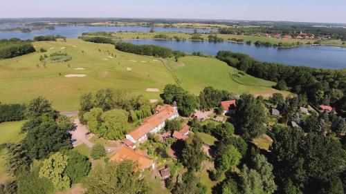 an aerial view of a house on a hill next to a lake at Van der Valk Golfhotel Serrahn - Adult Only in Serrahn