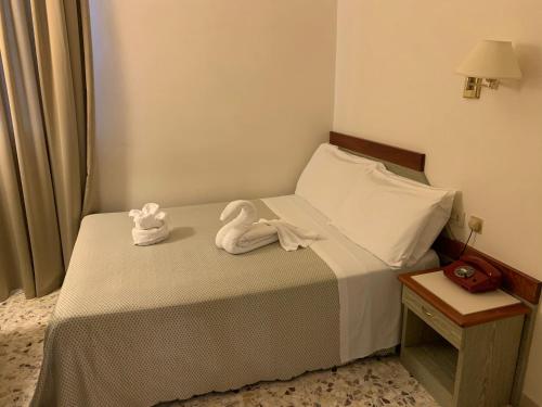 a hotel room with towels on a bed at Hotel Villa Tiziana in Marina di Pietrasanta