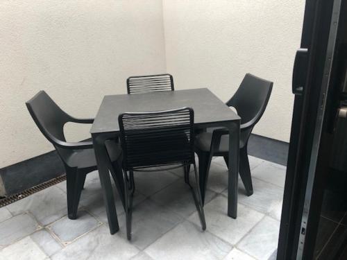 a black table and chairs sitting in a room at bloc79/zero in Knokke-Heist
