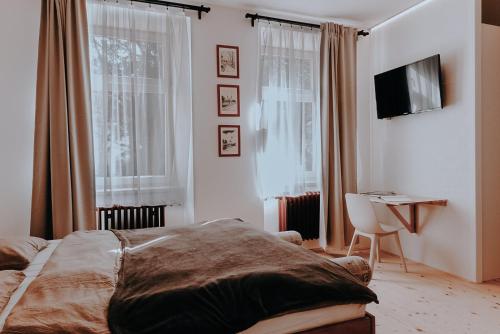 Postel nebo postele na pokoji v ubytování Apartmány Tiskárna