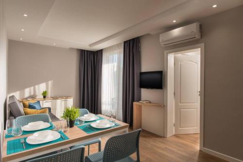 a living room with a dining table and chairs at Casa Paradiso Apartments in Ahtopol