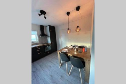 a kitchen with a dining room table and chairs at Lofoten_Beach_Eggum in Eggum