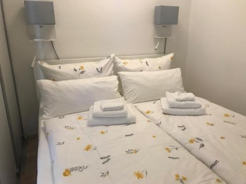 a bed with towels and pillows on it at Ferienwohnung Gassner in Piding