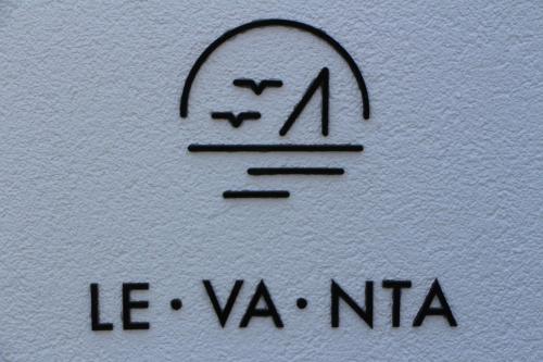 a drawing of a face on a white wall at Chill and Thrill Apartments in Mastichari