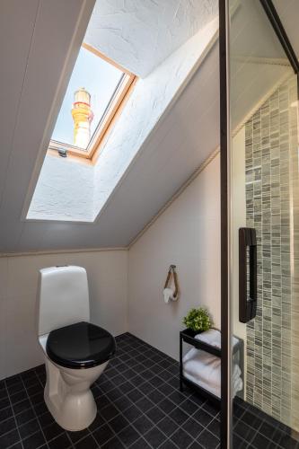 a bathroom with a toilet and a skylight at Pakri Parun in Paldiski