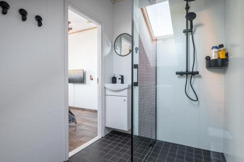 a bathroom with a shower with a glass door at Pakri Parun in Paldiski