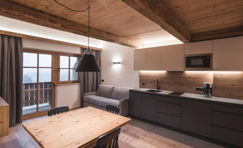 a kitchen and living room with a couch and a table at Unterweckerlerhof in Valle Di Casies