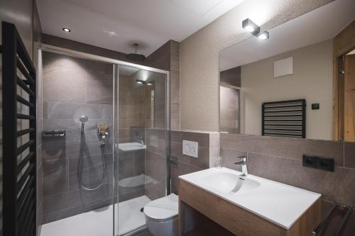 a bathroom with a shower and a sink and a toilet at Unterweckerlerhof in Valle Di Casies