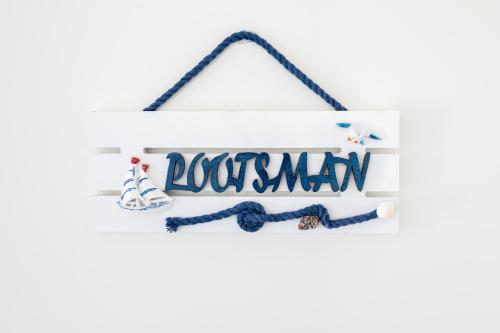 a sign with the word lockdown hanging on a white wall at Pakri Parun in Paldiski