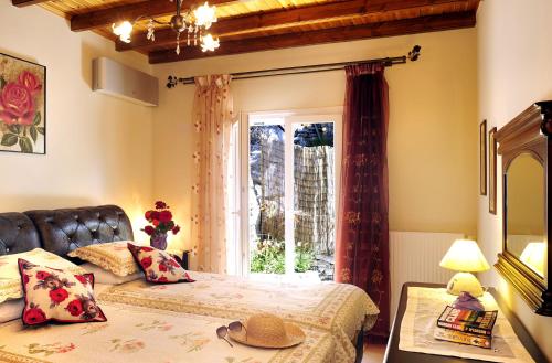 a bedroom with two beds and a window at Villa Edem in Kassiopi