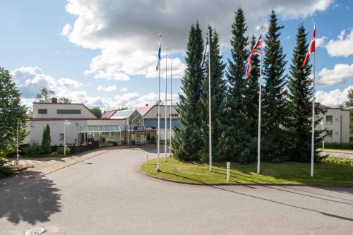 a street with flags in front of a building at Hotel Kurikka in Kurikka
