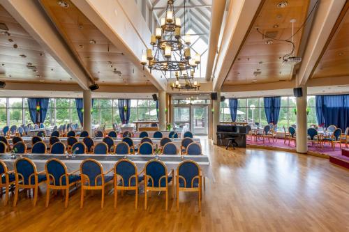 a large room with a table and chairs at Hotel Kurikka in Kurikka