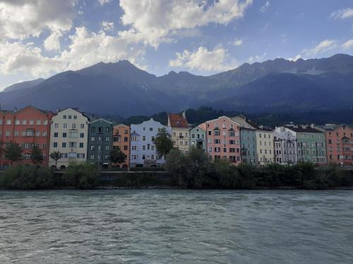 a city with a river and buildings and mountains at Apartment Serlesblick in Ellbögen